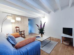a living room with a blue couch and a table at Gites de l'alouette in Boffres