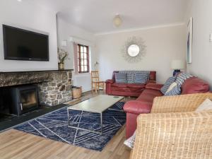 
a living room filled with furniture and a fire place at Amble Forge in Wadebridge
