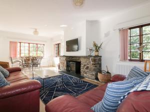 
a living room filled with furniture and a fire place at Amble Forge in Wadebridge
