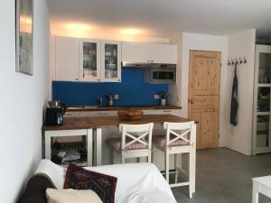 a kitchen with a table and chairs in a room at Chalet PapaGna Apartment in Zinal