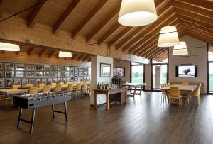 a large room with tables and chairs and wooden ceilings at Tenuta Santomè in Biancade