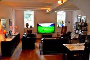 a living room with a flat screen tv on the wall at Col du Fatten in Beek