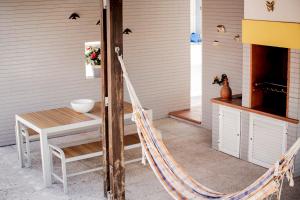 a porch with a table and a hammock at casa Jone in Tomar