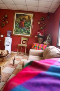 a living room with a painting of a man with fruit at Hotel Ipsan Nah in La Esperanza