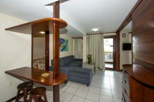 a living room with a couch and a table and chairs at Blue Marlin Apartaments Ponta Negra-Natal-RN in Natal