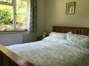 a bedroom with a bed and a window at Wingmore in Salisbury