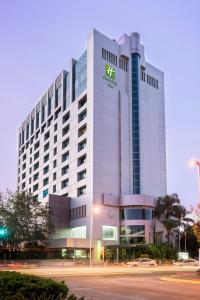a tall white building with a sign on it at Holiday Inn Guadalajara Select by IHG in Guadalajara