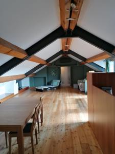 an attic room with a wooden table and chairs at Arona 01 attic mansarda secondo piano no ascensore no hotel in Arona