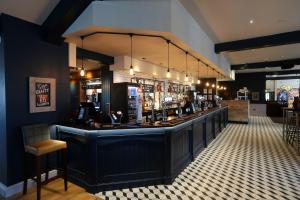 a bar in a restaurant with a lot of alcohol at Boundary, Alfreton by Marston's Inns in Alfreton