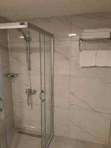 a shower with a glass door in a bathroom at Alkan Hotel in Marmaris