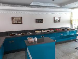 a buffet line in a restaurant with blue cabinets at Alkan Hotel in Marmaris
