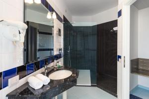 a bathroom with a sink and a shower at Rada Siri in Montepaone