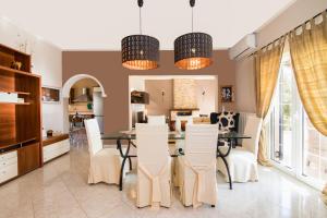 a kitchen and dining room with a table and chairs at Sea View Estate Helios in Perama
