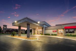 an empty parking lot in front of a store at Red Roof Inn Lewisville in Lewisville