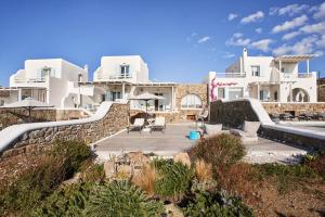 a view of a house with a stone wall at Paradisia Villas in Tourlos