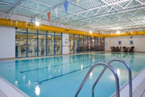 a large indoor swimming pool in a building at Holiday Inn Chester South by IHG in Chester