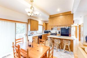 a kitchen with a wooden table and a dining room at Seaside Serenade in Seaside