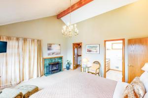 a bedroom with a bed and a fireplace at Seaside Serenade in Seaside