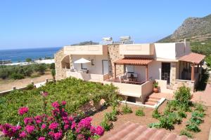 a house with a view of the ocean at Romantica Apartments in Falasarna