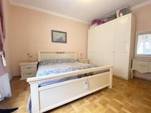 a bedroom with a large white bed and cabinets at Baden-BadenSpaApartment in Baden-Baden