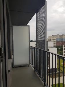 a white door on a balcony with a view at Sun Apartment Katowice Chorzów in Katowice
