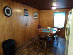 a dining room with a wooden table and chairs at The Diamond Hideaway in Murfreesboro