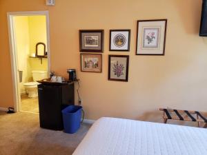 a bedroom with a bed and framed pictures on the wall at Battlefield Bed & Breakfast in Gettysburg