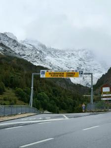 a sign on the side of a road with a mountain at Sweet Home ski out in Valtournenche