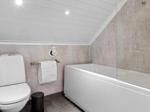a bathroom with a toilet and a tub and a sink at 7 person holiday home in Bud in Bud +43 photos