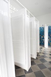 a row of white toilets in a room with a tile floor at República Hostel Cartagena in Cartagena de Indias
