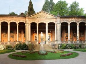 a large building with a garden in front of it at Baden-BadenSpaApartment in Baden-Baden