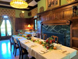 a dining room with tables and chairs and a fireplace at Mercersburg Inn in Mercersburg