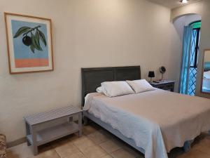 a bedroom with a bed and a picture on the wall at Las Alamedas in Guanajuato