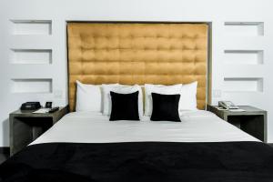 Ein Bett oder Betten in einem Zimmer der Unterkunft Riande Aeropuerto Hotel Casino