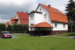a large white house with an orange roof at Hotelik Villa in Legnica