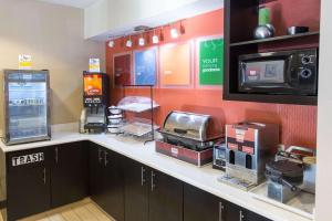 a kitchen with a counter with a microwave and appliances at Comfort Inn Pittsburgh Crafton in Pittsburgh
