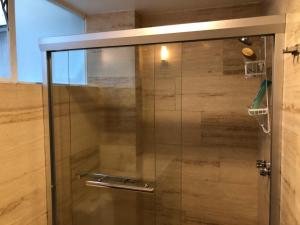 a shower with a glass door in a bathroom at Caravansaro Vazquez de Mella 347 Polanco in Mexico City