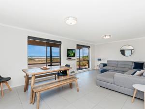 a living room with a couch and a table at Seaclusion in Port Fairy
