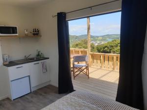 a room with a kitchen and a balcony with a view at Wild Days Accommodation in Palm Beach