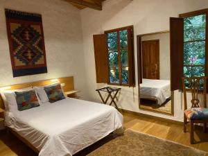 a bedroom with a bed and a large mirror at Terrazas de Salento in Salento