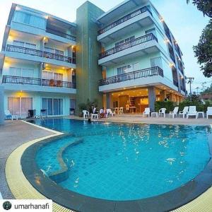 a large swimming pool in front of a building at Ao Nang Miti Resort in Ao Nang Beach
