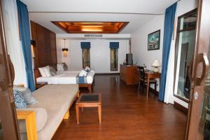 a living room with a bed and a couch at Railay Village Resort in Railay Beach