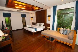 a hotel room with two beds and a couch at Railay Village Resort in Railay Beach