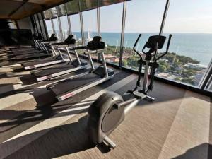 a row of exercise bikes in a gym with the ocean at the andromeda condominium seaview in Pattaya South