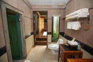 a bathroom with a toilet and a hallway with a staircase at Railay Village Resort in Railay Beach