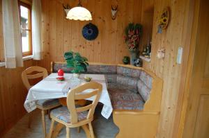 a dining room with a table and a couch at Haus Moser in Altaussee