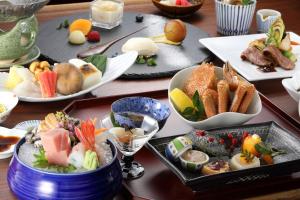 a table with many plates of food on it at Heiseikan Shiosaitei Hanatsuki in Hakodate