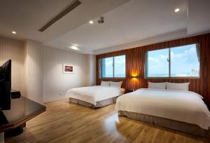 Oursea Hotel tesisinde bir odada yatak veya yataklar