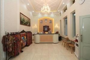 a man sitting at a counter in a store at Hotel Besar Purwokerto in Purwokerto