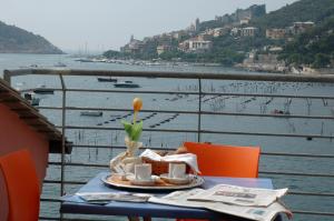a cake sitting on top of a table next to a body of water at Residence Le Terrazze in Portovenere